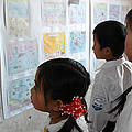 School children looking for the prize winning drawing at a competition